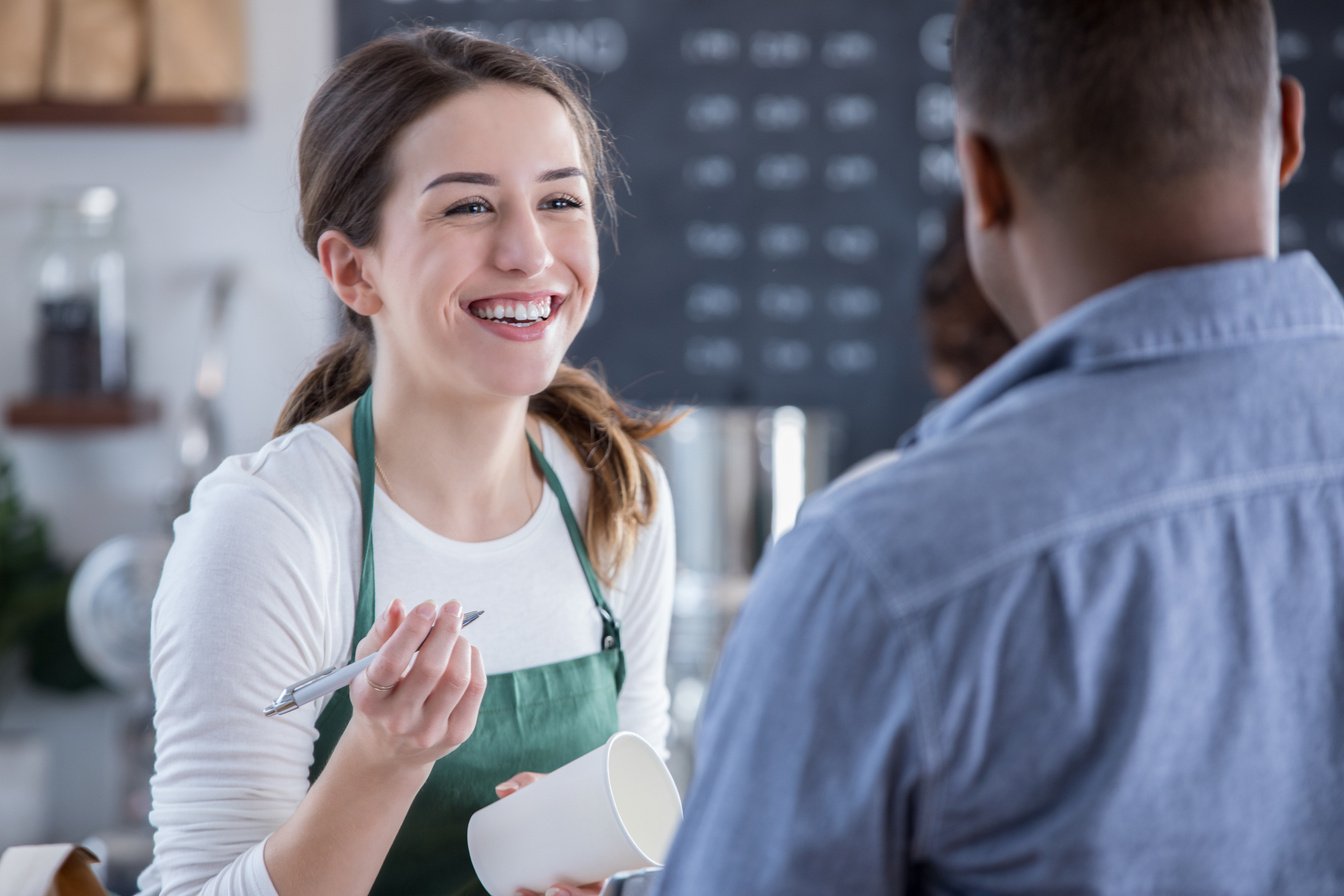 Attractive barista takes customer's order